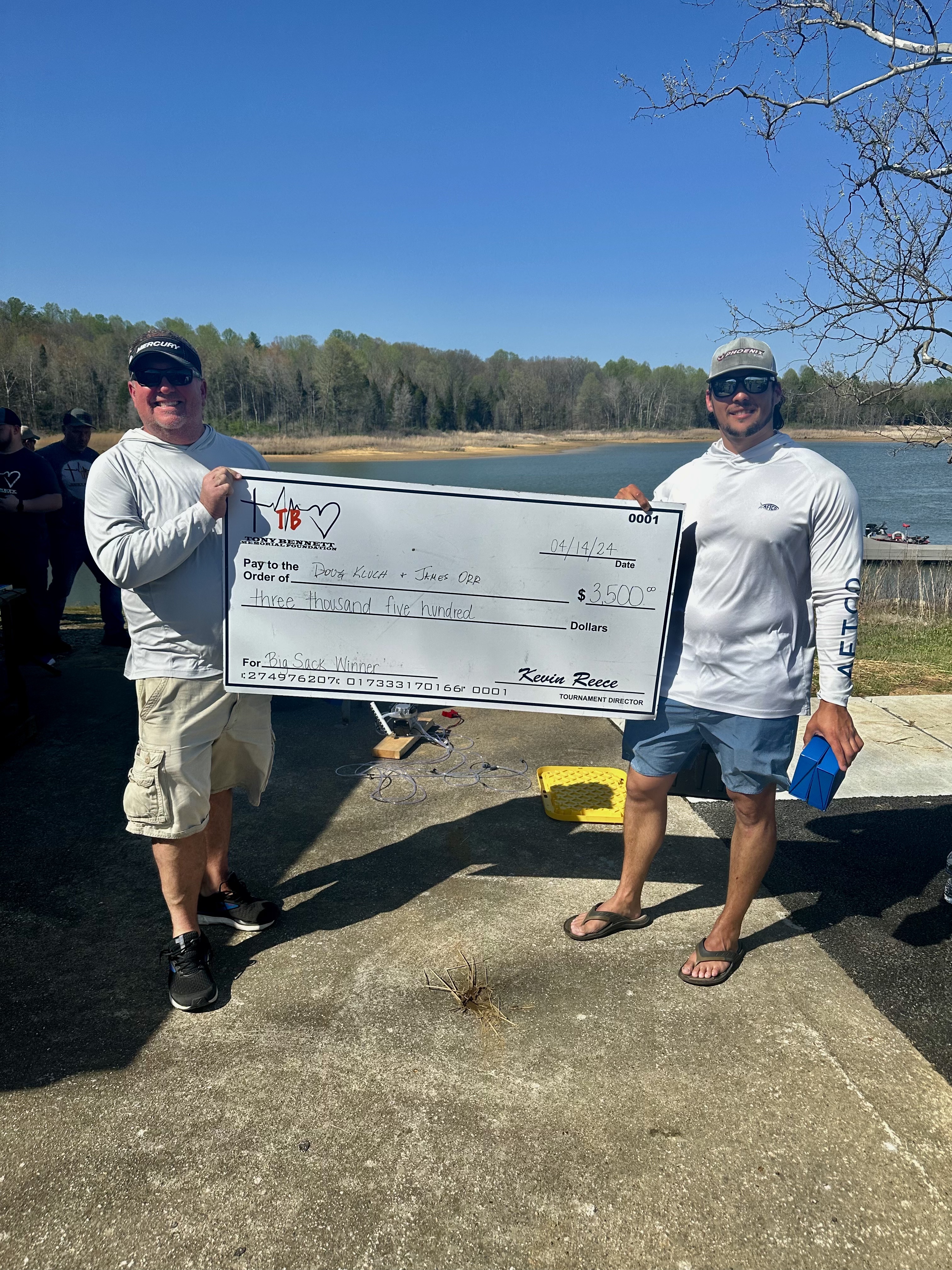 Two Bass Fishermen holding their winning check.