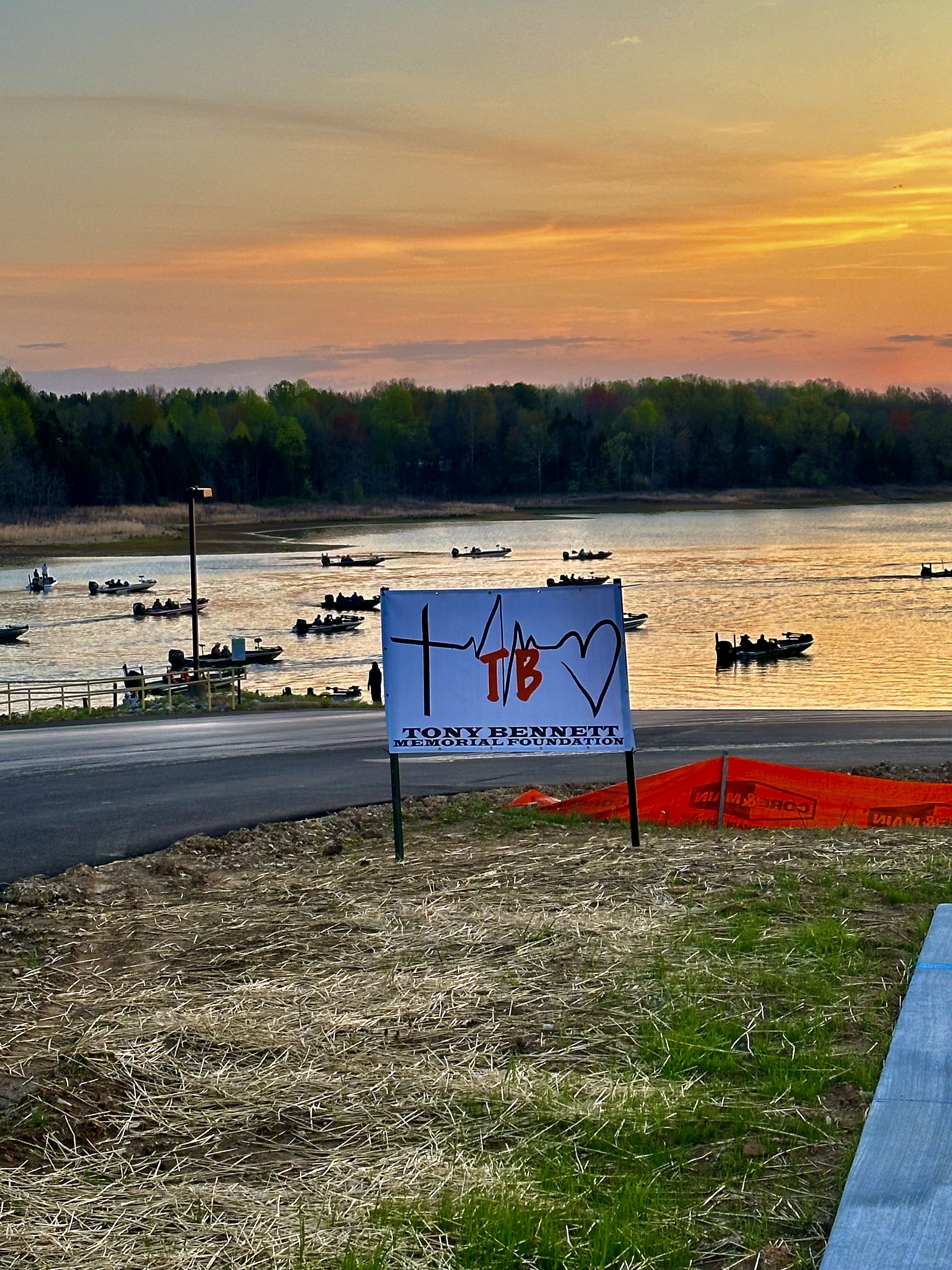 TBM Sign with sunset backdrop on the lake.