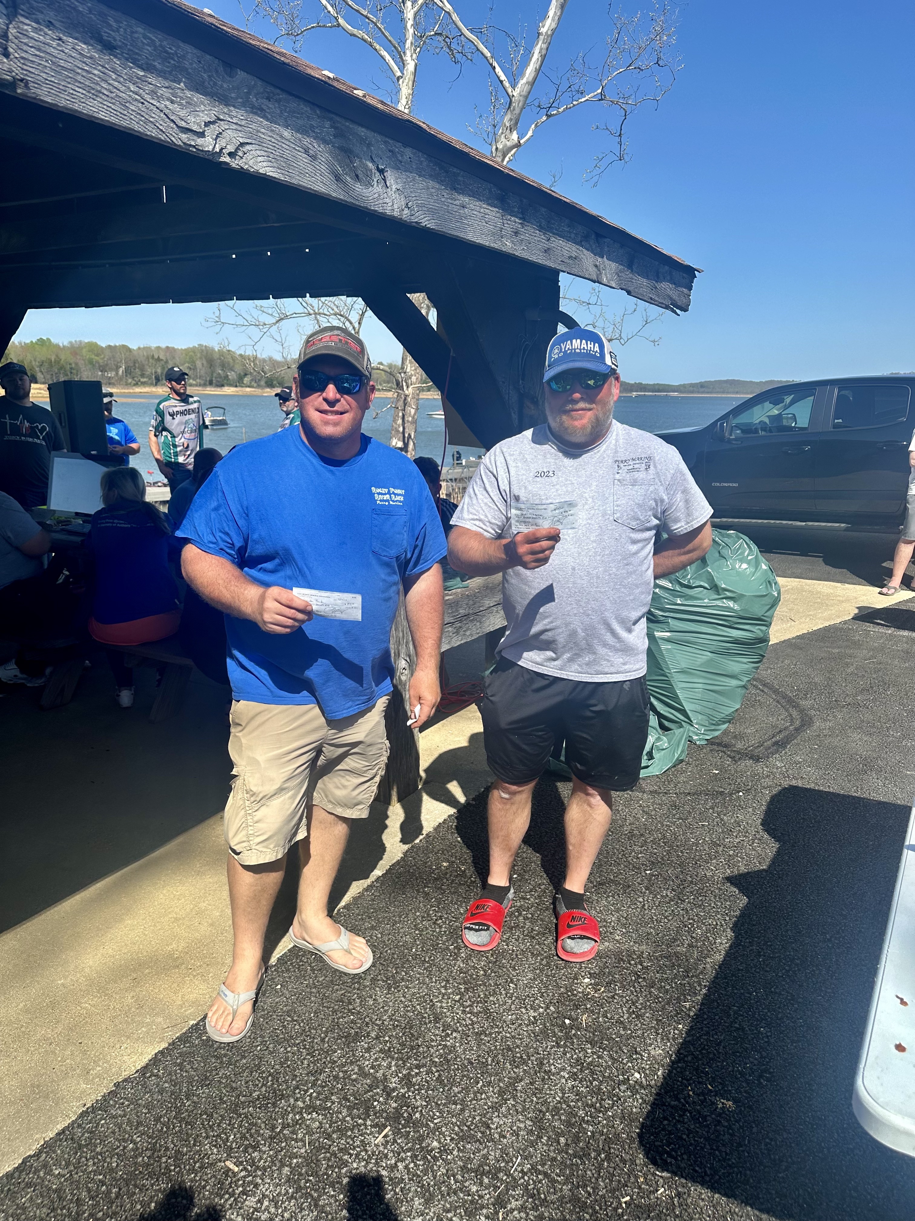 Two Bass Fishermen holding their prize plaques.