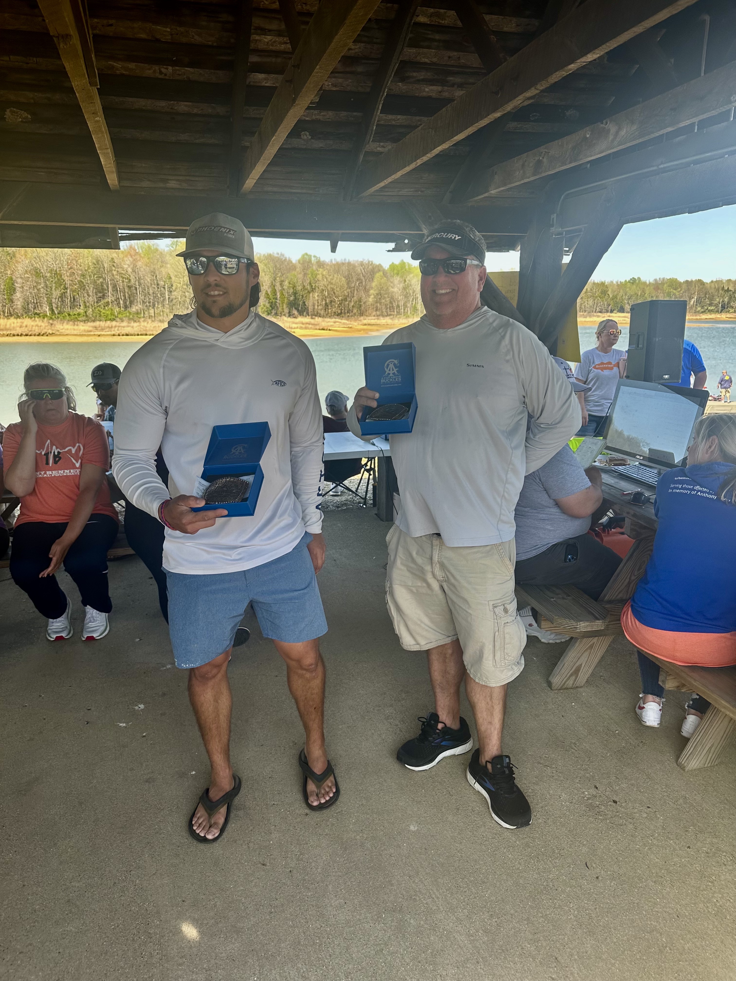 Two Bass Fishermen holding their prize plaques.