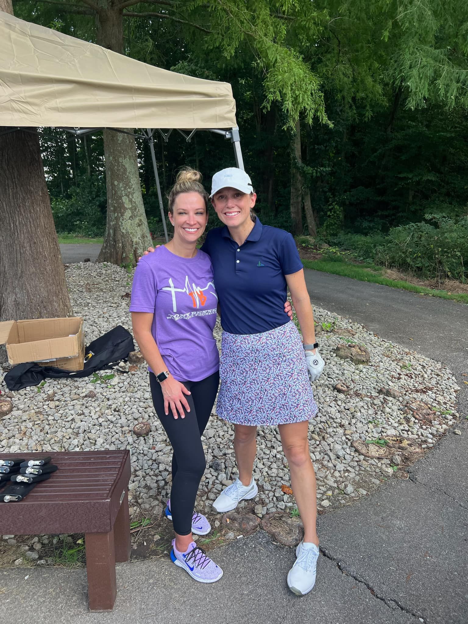 Two golfers standing together ready to play golf.