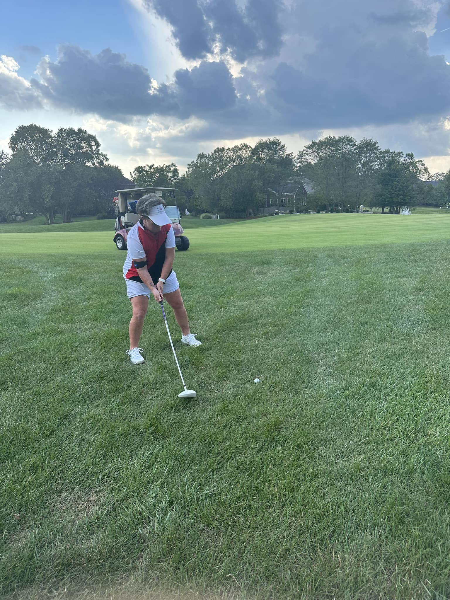 A golfer hitting a golf ball.