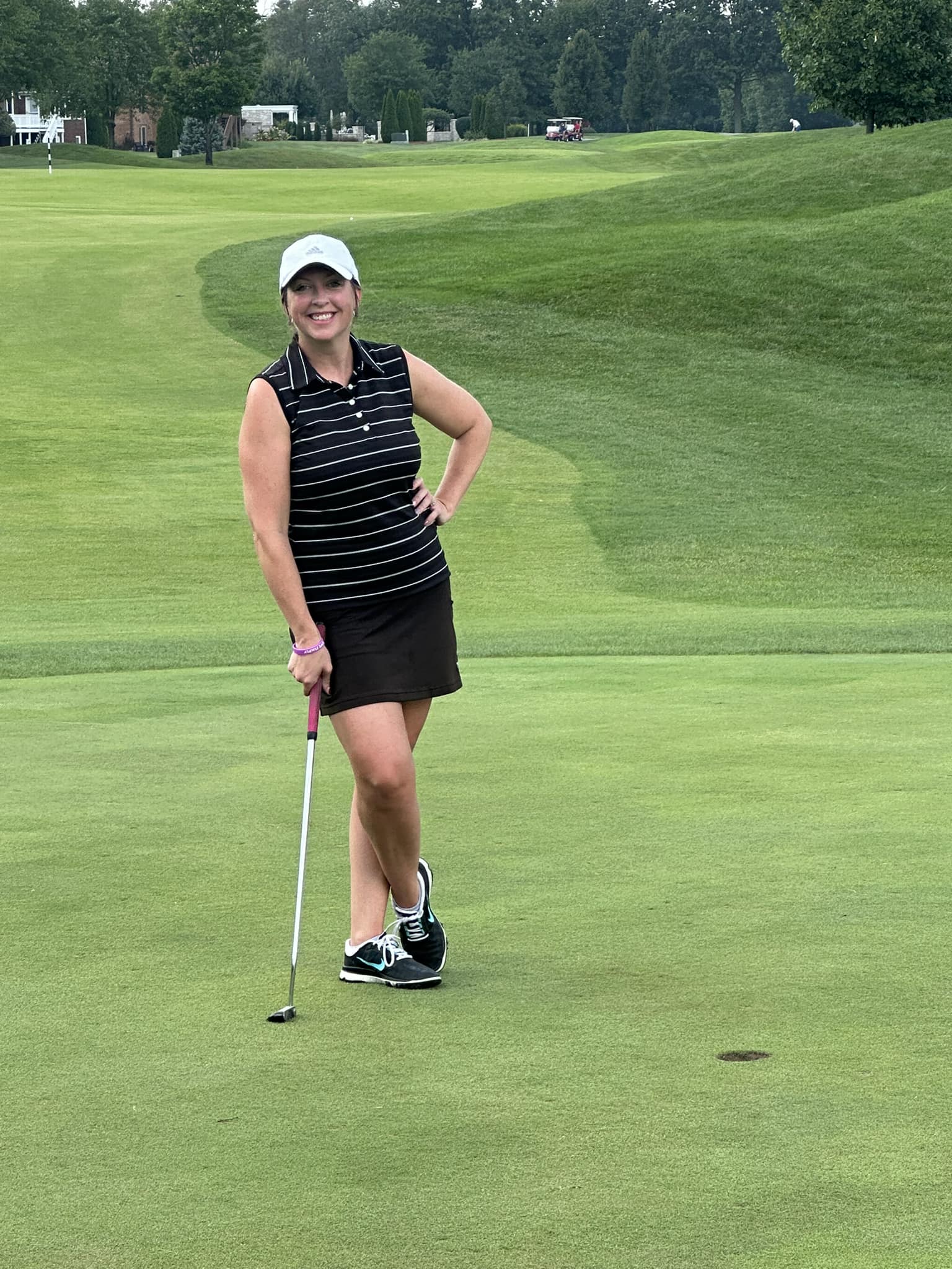 A golfer lining up for a put.