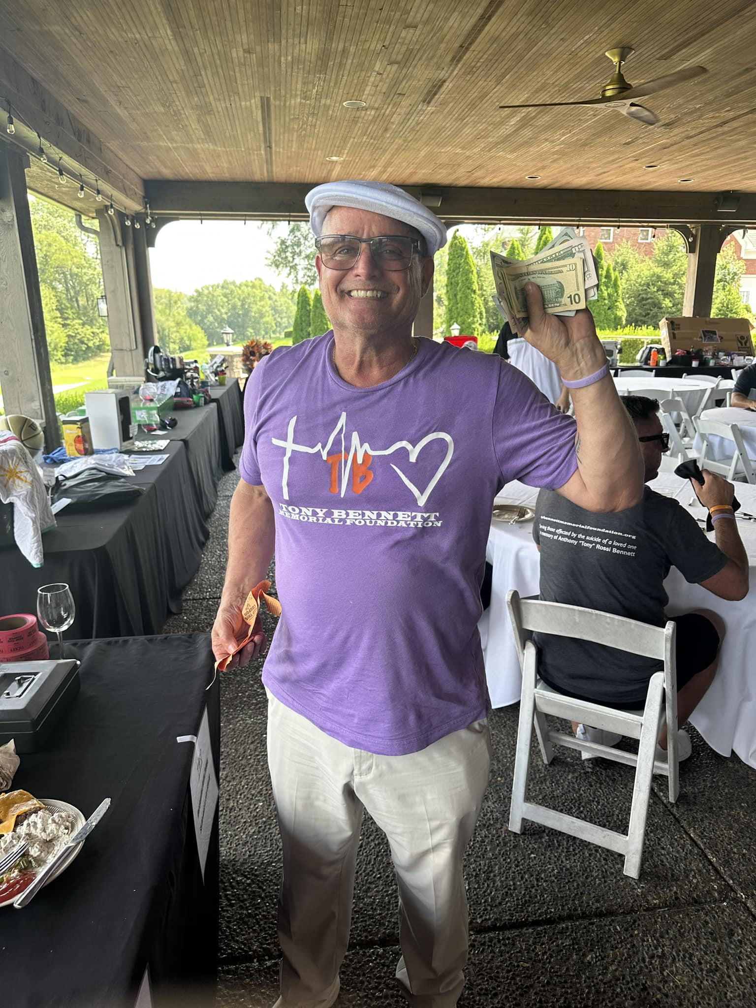 The winner holding his prize money.